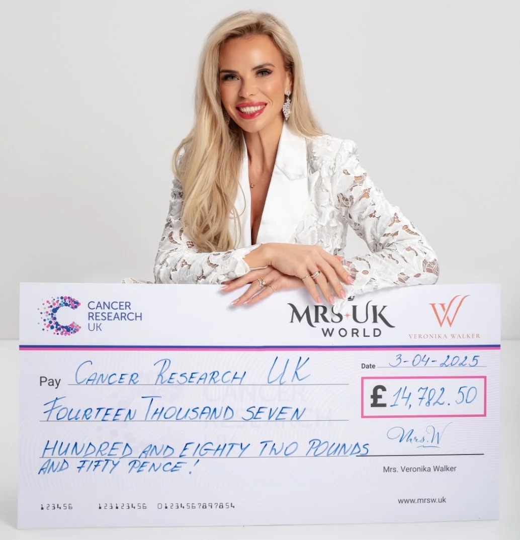 Veronika Walker presenting a fundraising cheque to Cancer Research UK