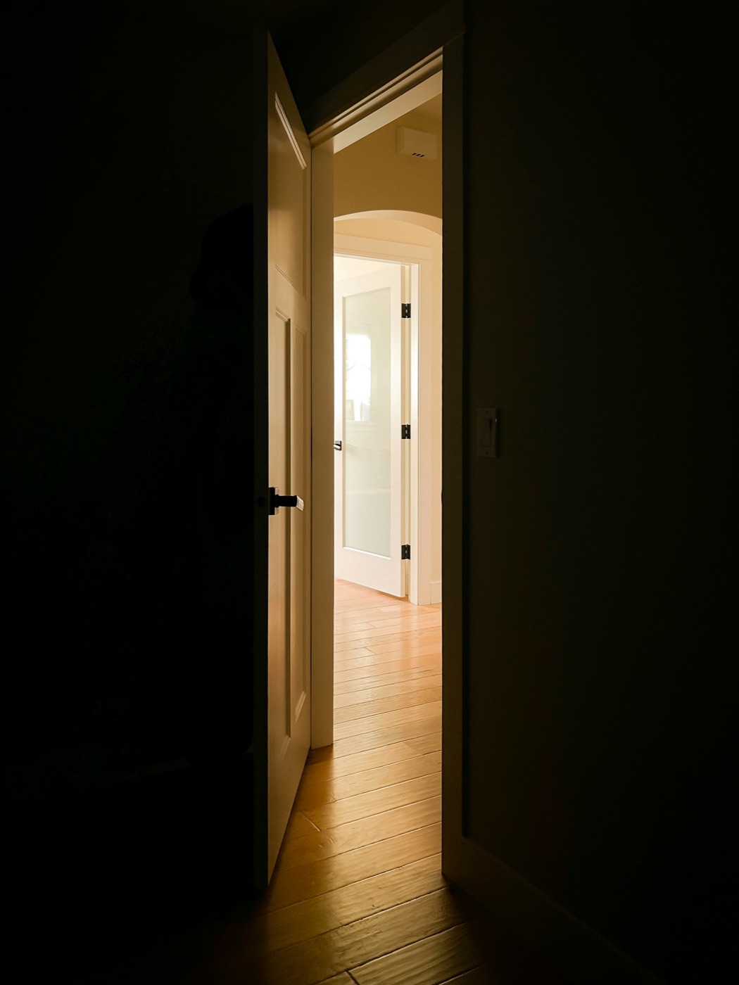 An open door with light beyond