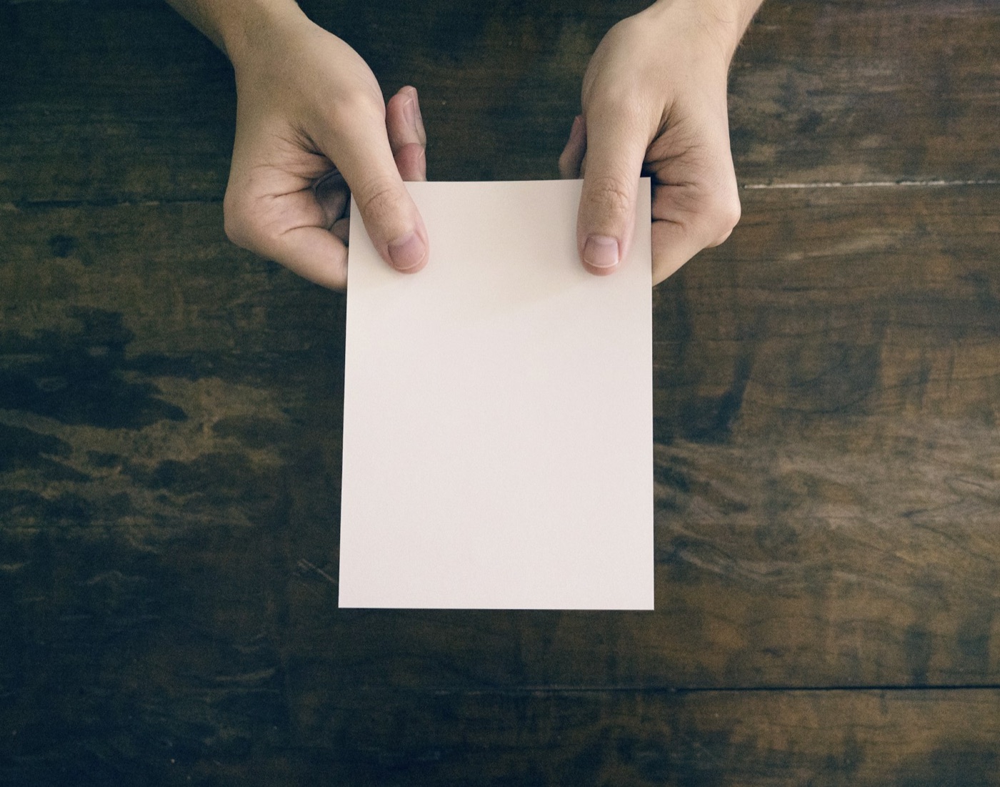 Hands holding a note