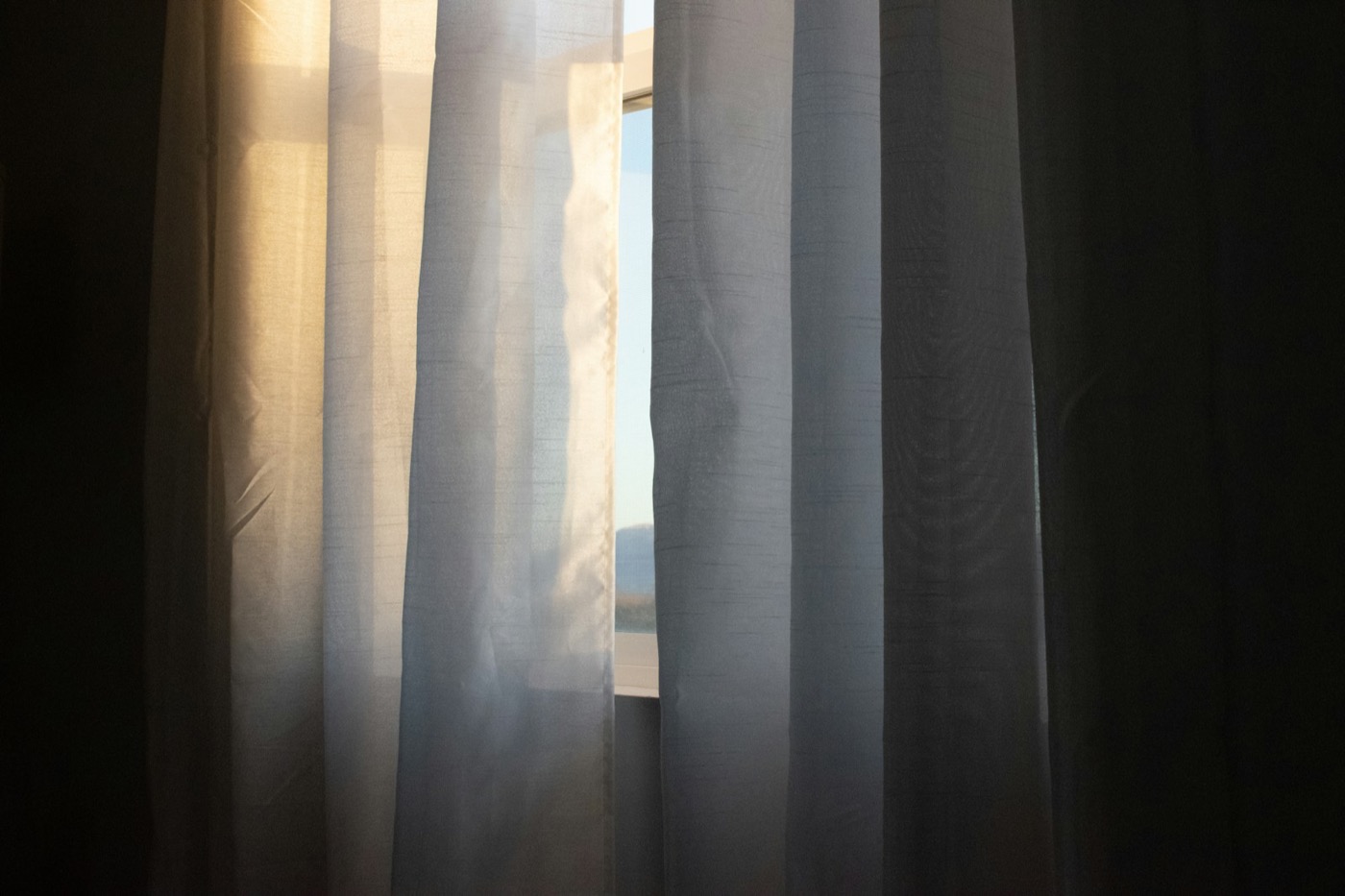 Daylight coming through a gap in sheer curtains