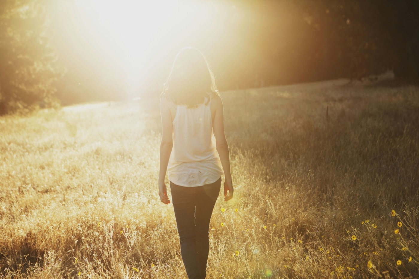 Woman walking through a golden field