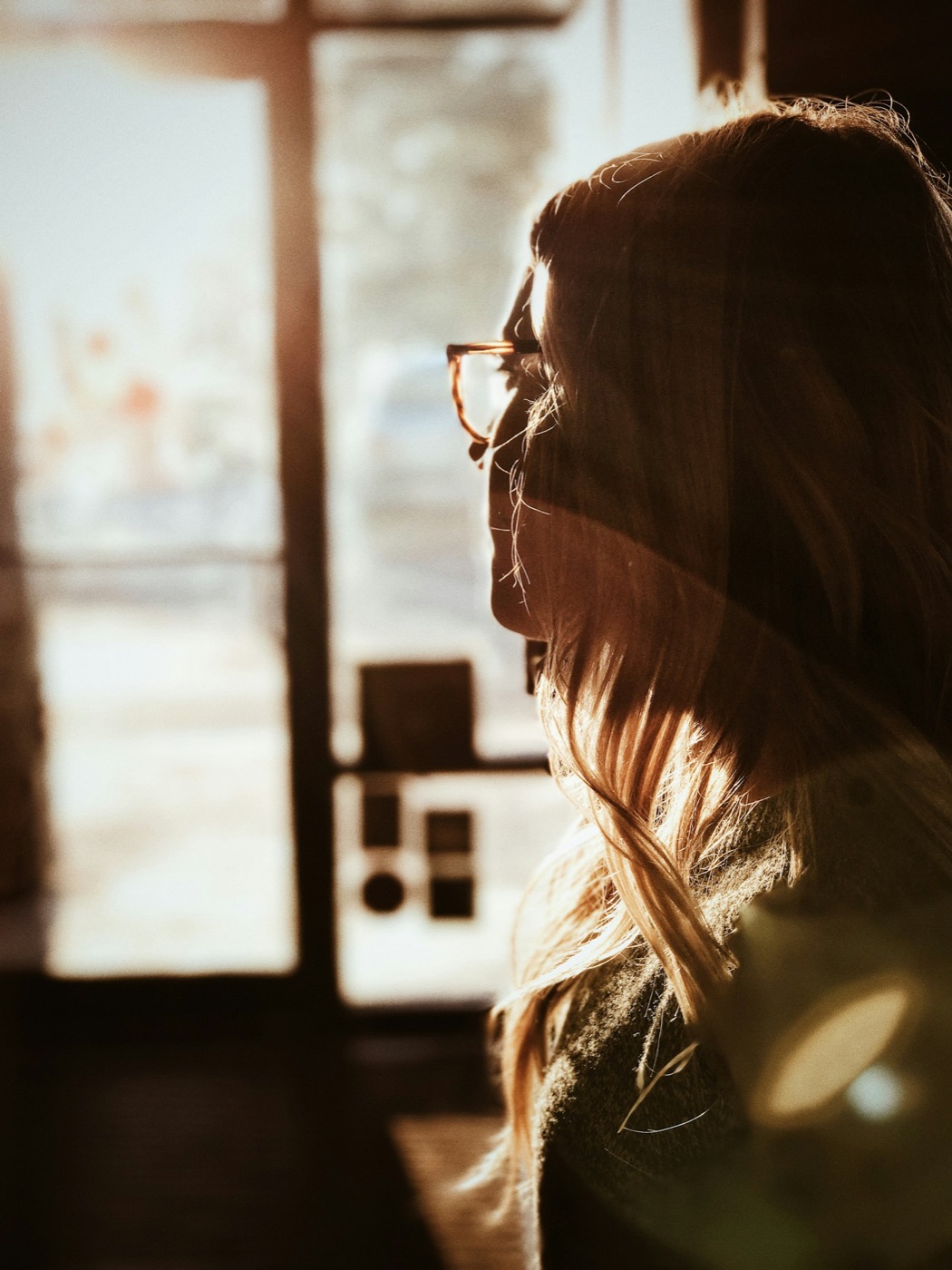 Woman in thought by a window
