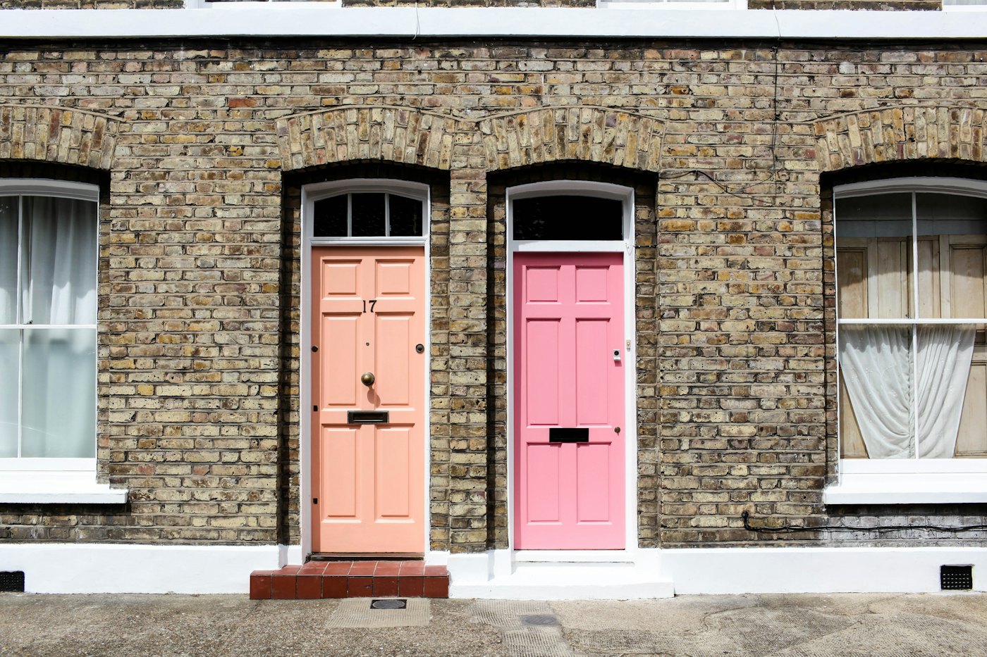 Two ordinary terraced front doors side by side